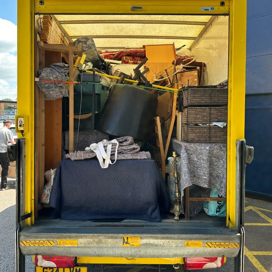 Furniture strapped and blanket-wrapped inside the van after a clearance